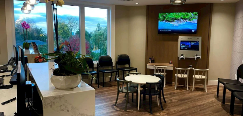 Just 4 Kidz Dental welcoming waiting area with kid gaming station and activity table in Ottawa
